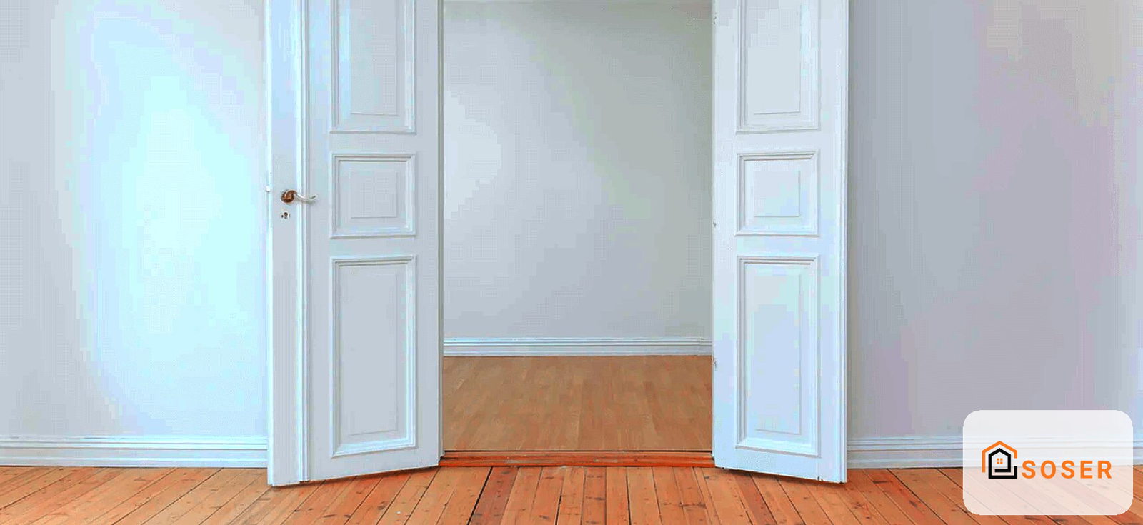 Interno di stanza con doppia porta bianca in legno, pavimento in parquet e parete con rivestimento bicolore