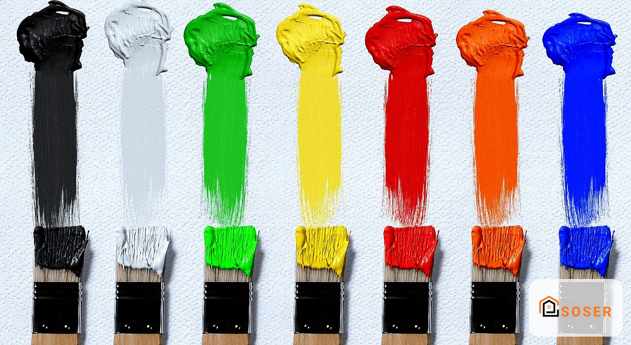 Sette pennelli con vernici colorate: nero, bianco, verde, giallo, rosso, arancione e blu su sfondo chiaro