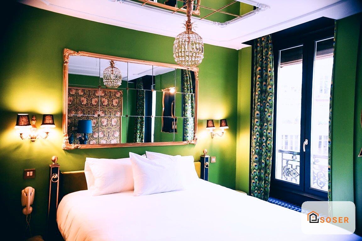 Camera da letto moderna con pareti verde smeraldo, specchio dorato e lampadari in stile contemporaneo